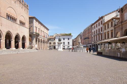 an empty street in a city with people walking around at TEATRUM LOFT Teatro Galli -Jacuzzi in camera in Rimini
