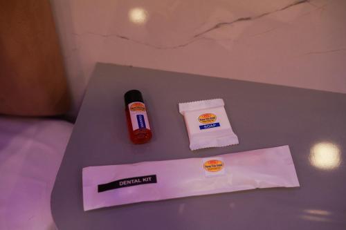 a table with a napkin and a bottle of ketchup at Pavan Vela Grand in Dindigul