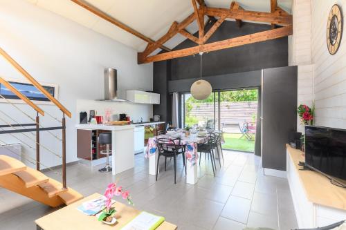une cuisine et une salle à manger avec une table et des chaises dans l'établissement Le Loft Sablais, 3 étoiles de l'Office de Tourisme, à Les Sables-dʼOlonne