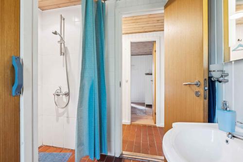 a bathroom with a shower and a white sink at Dog-Friendly Holiday Oasis With Peace And Nature in Hadsund