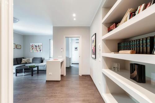a living room with a couch and bookshelves at Como Lake Amazing View - byMyHomeinComo in Moltrasio