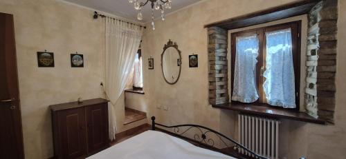 a bedroom with a bed and a window and a mirror at La Casa di Edo 