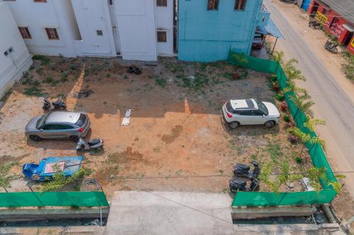 two cars parked in a yard next to a building at Pavan Vela Grand in Dindigul