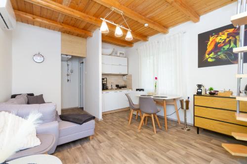 a living room with a couch and a table at Hilltop Wellness Haven W AC & Jacuzzi by NW in Recsk