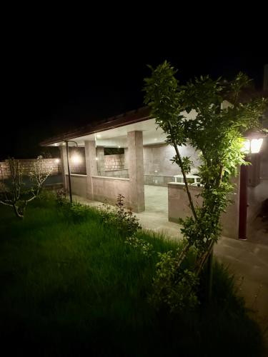 a building lit up at night with a green yard at Dream house in Yeghegnadzor