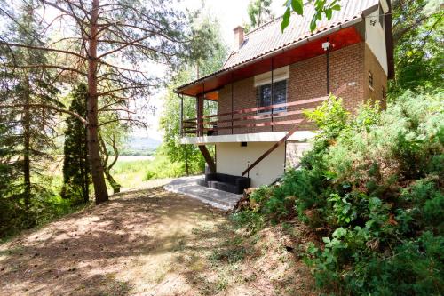 a brick house with a balcony on a hill at Hilltop Wellness Haven W AC & Jacuzzi by NW in Recsk