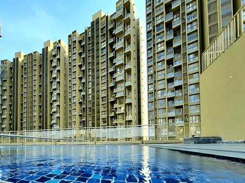 a row of tall apartment buildings with a swimming pool at Runal Gateway, Ravet Pune in Dehu Road