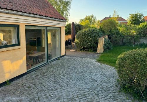 a brick walkway next to a house at Historic Laundry House By Gentofte Lake in Gentofte
