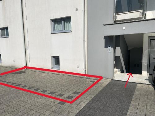 a red mat in front of a building at Beach Garden Terrace Njivice in Njivice