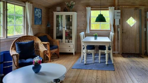 a living room with a table and chairs at Blue Cottage On Idyllic Askø in Maribo