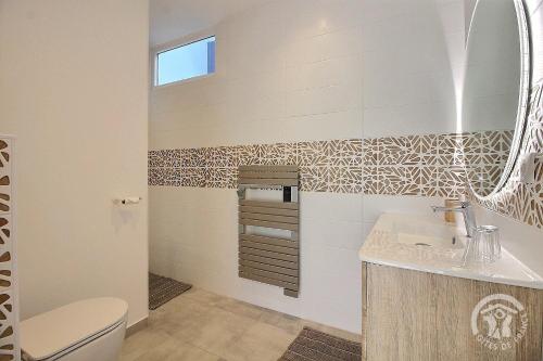 a bathroom with a sink and a mirror at Le val d'ic in Pordic