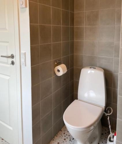 a bathroom with a toilet and a toilet paper roll at Farmhouse With Great Views On Langeland 