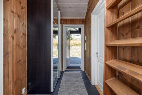 a hallway of a house with wooden walls and wooden shelves at Mountain Cabin With Panoramic Views In Sjusjøen in Sjusjøen