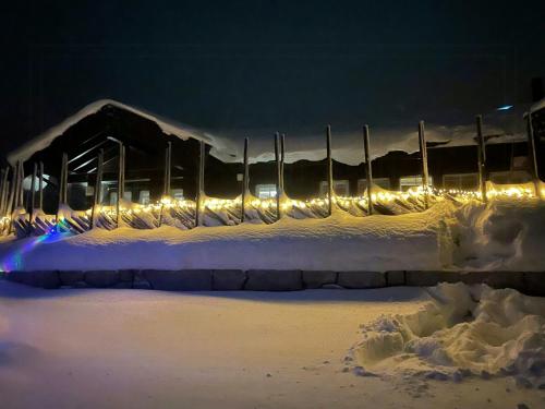 a tennis court covered in snow at night at Mountain Cabin With Panoramic Views In Sjusjøen in Sjusjøen