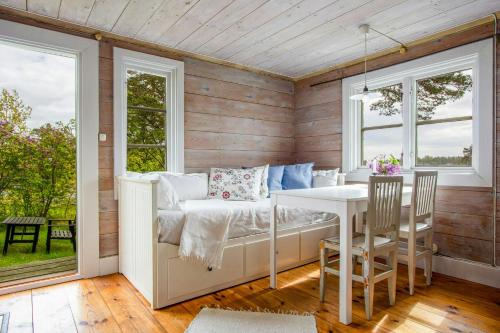 a room with a bed and a table and chairs at Archipelago Cottage With Private Pier In Tjust in Loftahammar