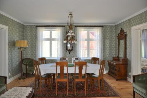 a dining room with a table and chairs at Turn-Of-The-Century House Near Lake Vikarn in Matfors
