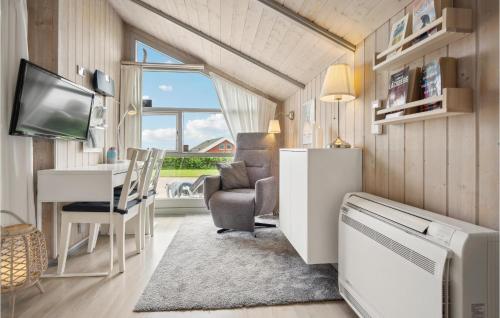 a tiny house with a living room and a desk at Cassiopeia in Sjølund
