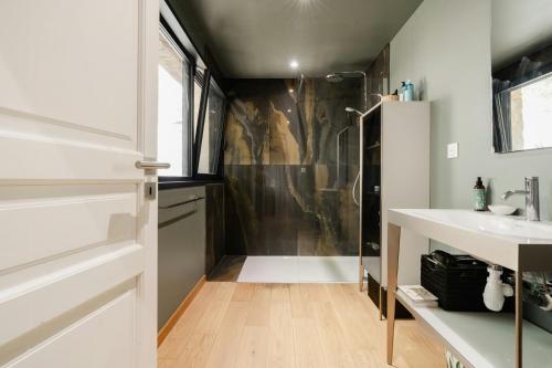 a bathroom with a shower and a sink at Hilltop Sheepfold In Castelnou in Cazilhac