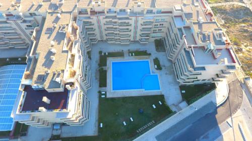 an aerial view of a building with a swimming pool at Beach Apartment Furadouro in Ovar