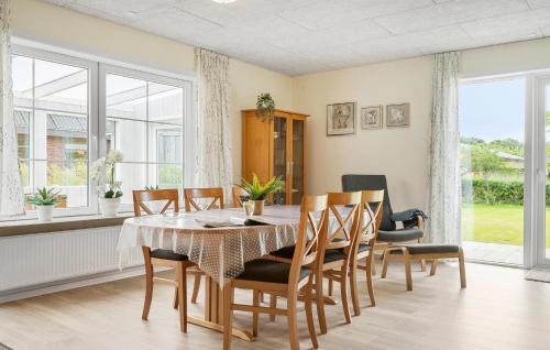 a dining room with a table and chairs at Nice Home In Skjern With Wifi in Skjern