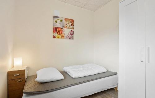 a bedroom with a bed and a picture on the wall at Nice Home In Skjern With Wifi in Skjern