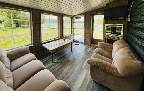 a living room with two couches and a table at 2 Bedroom Awesome Home In Östmark in Östmark