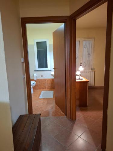 a bathroom with a toilet and a sink and a mirror at Casa Antonia in Vecchiano