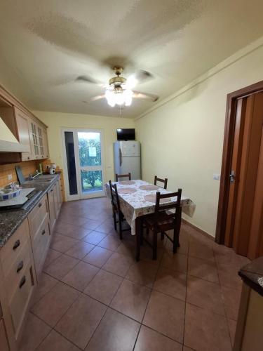 a kitchen with a table and chairs and a refrigerator at Casa Antonia in Vecchiano