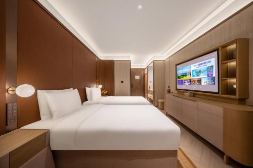 Jingdong Headquarters Crystal Orange Hotel, Yizhuang, Beijing房間的床