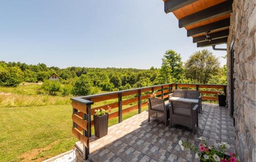 a patio with a table and chairs on a balcony at Lovely Home In Lipovlje in Lipovlje