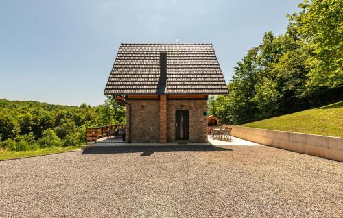 a small brick building with a roof on a hill at Lovely Home In Lipovlje in Lipovlje