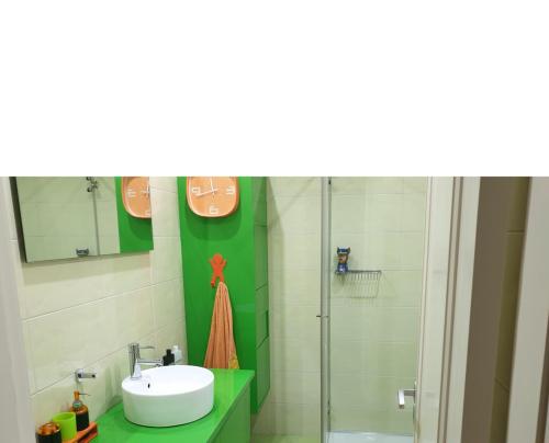 a bathroom with a sink and a shower at Beach Apartment Furadouro in Ovar