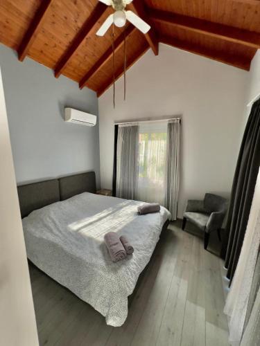a bedroom with a bed and a chair and a ceiling at 4 bed room Villa Alsancak Girne in Lageia