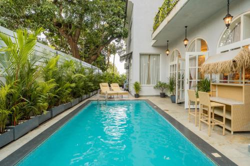 a swimming pool in the backyard of a house at ELIVAAS Signature Casa Ritzy Mediterranean 5 BHK Hideaway with Pool near Popular Beaches in Calangute
