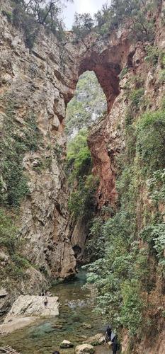 a rocky mountain with a bridge over a river at Dar El Mghouchi in Chefchaouene