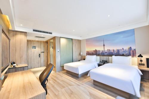 Atour Hotel Harbin Songbei Ice and Snow Worldにあるベッド