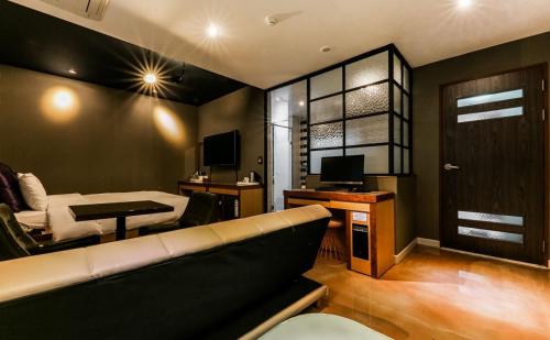 a living room with a couch and a table at Hotel Some in Daejeon