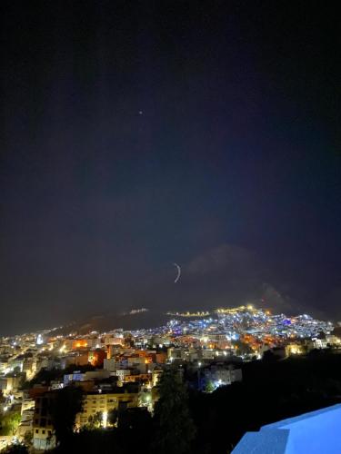 a view of a city lit up at night at Dar El Mghouchi in Chefchaouene