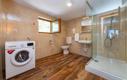 a bathroom with a washing machine and a toilet at 3 Bedroom Gorgeous Apartment In Seline in Seline
