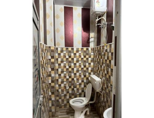 a bathroom with a toilet and a sink at SLH guest house in Faizābād