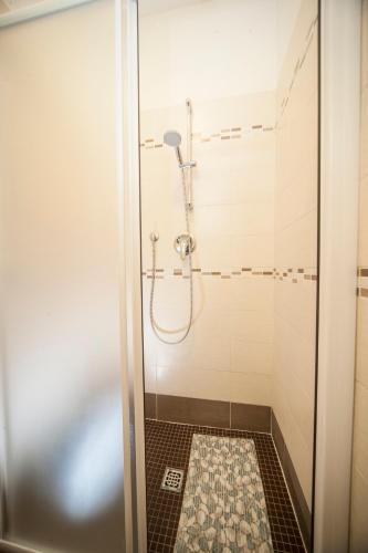 a shower with a glass door in a bathroom at Hotel Taormina in Riccione