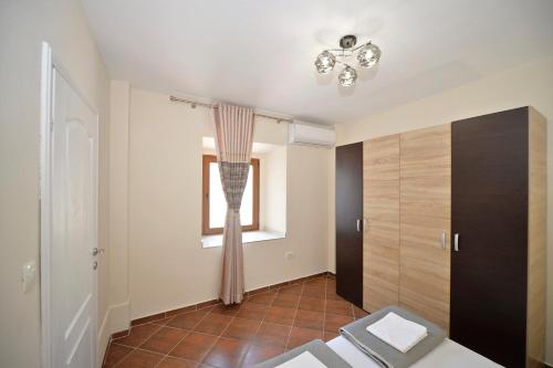 a living room with a window and a window at Kuzman Apartments in Kotor