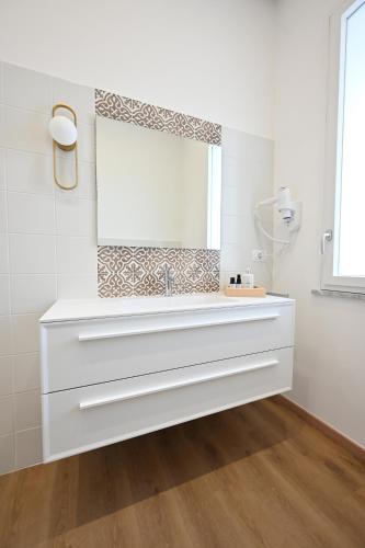 a bathroom with a sink and a mirror at Spazio83 Comfort Rooms in Fisciano