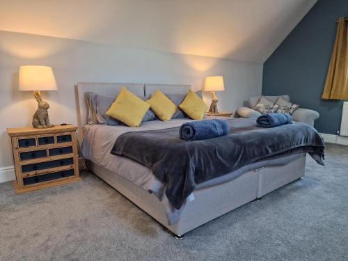 a bedroom with a large bed with two lamps at Southbarn - Spectacular Country Home in Winestead