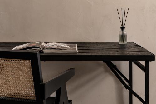 a table with a book and a vase on it at Abella Suites Embonas in Émbonas