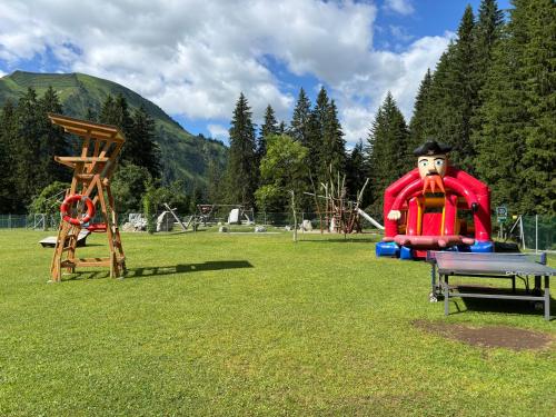 a park with a playground with a large inflatable at Appartements Berwang in Berwang