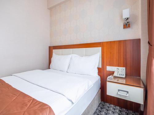 a hotel room with a bed and a phone at Mint Residence Taksim in Istanbul