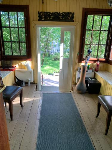 a room with an open door with a guitar in it at A Lovely House with A Garden in Helsinki in Siltamäki