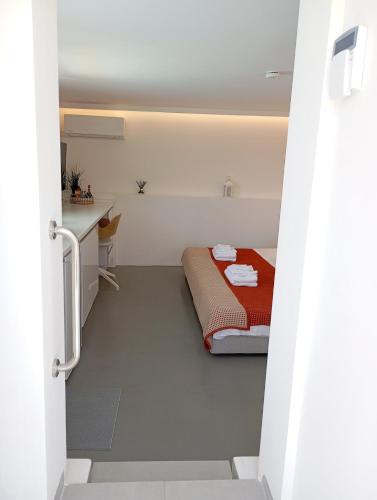 a small room with a bed and a desk at Anemelia & Helios Studio in Anavissos