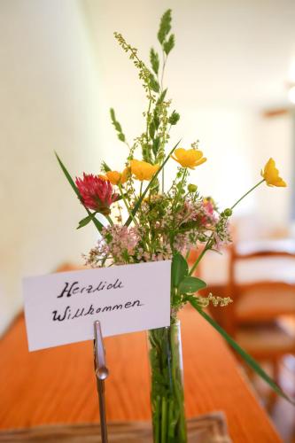 a vase filled with flowers on a table at Haus Tannruh in Bernau im Schwarzwald